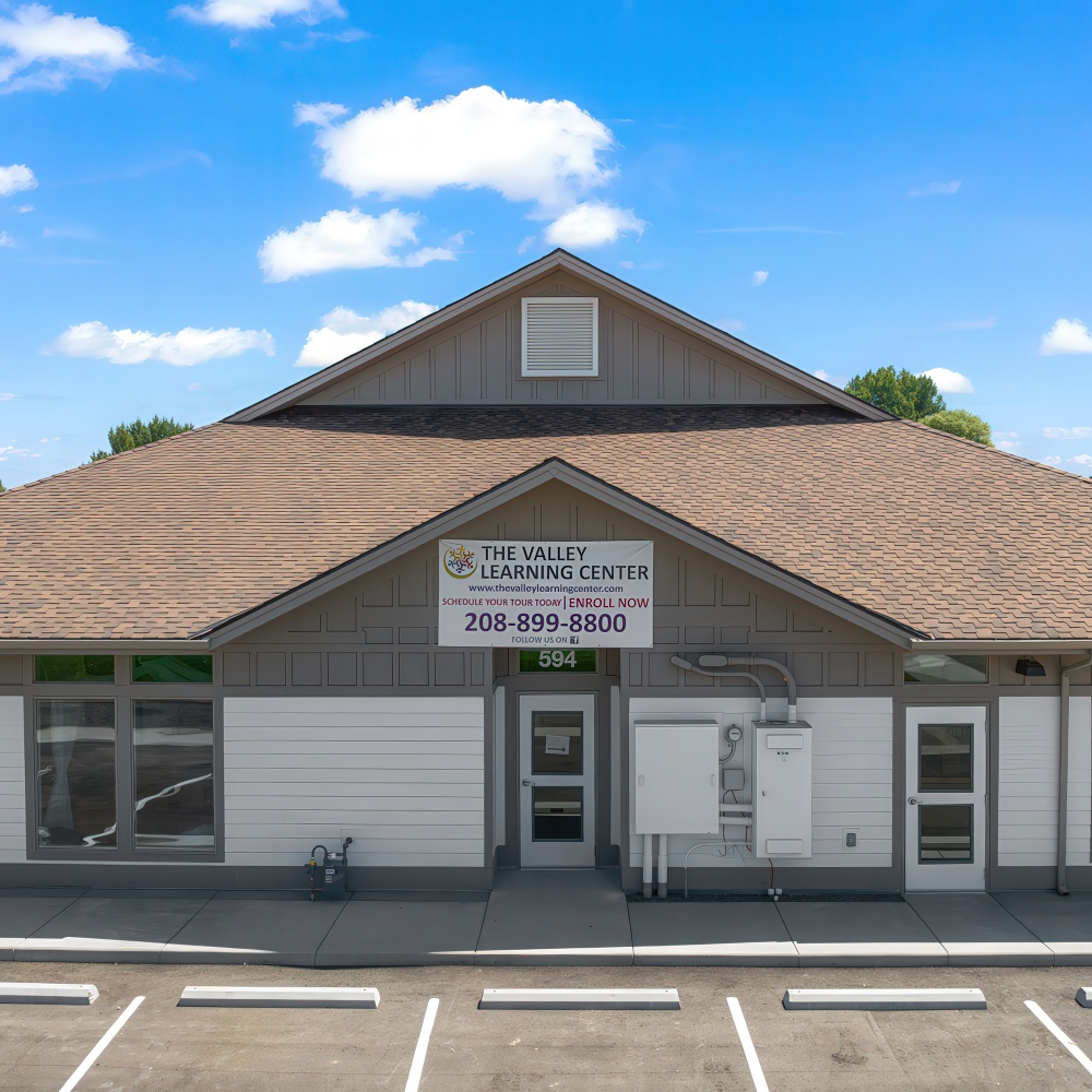 Exterior of the building with sign and contact info.