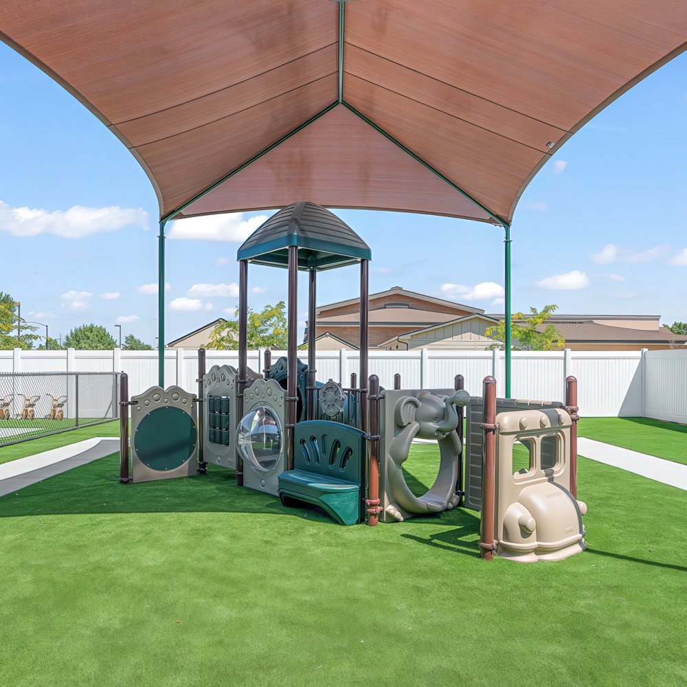 Outdoor playground with climbing structure and canopy.