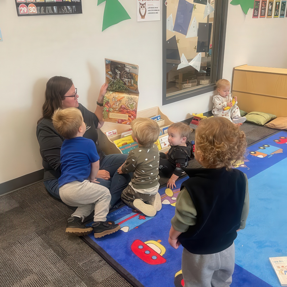 Teacher reads a storybook to a group of toddlers.