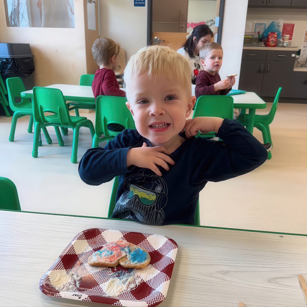 Child shows off colorful cookies during snack time.
