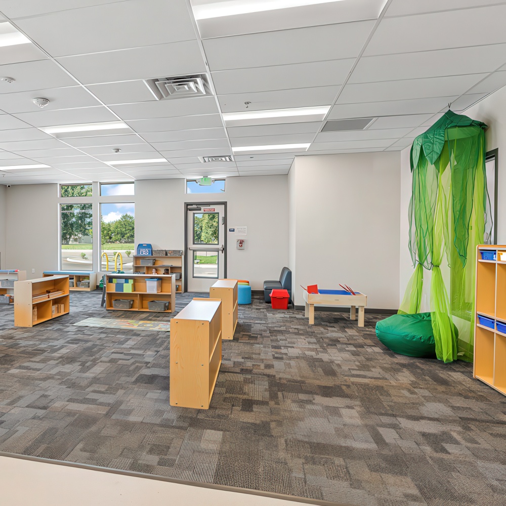 Classroom with reading nook and play areas.